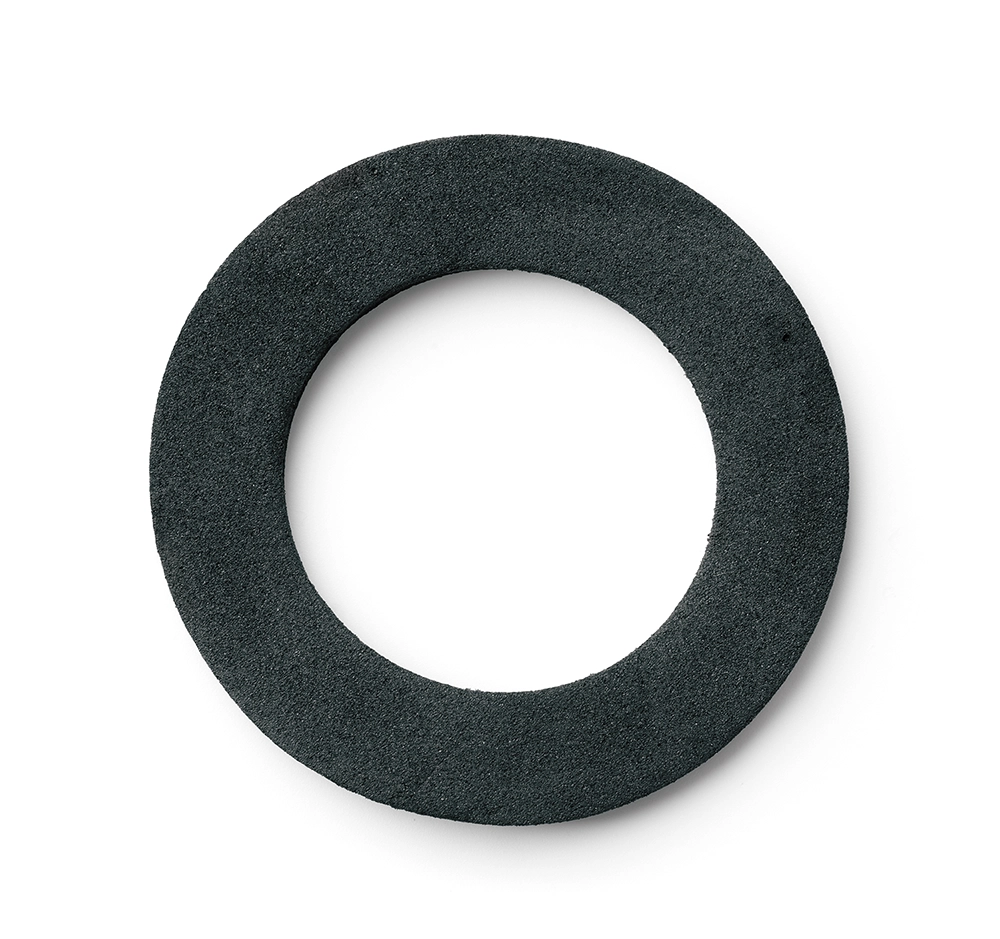 Neoprene gasket ring isolated on a white background, showing a flat circular sealing component used in industrial applications